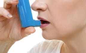 Adult woman using inhaler