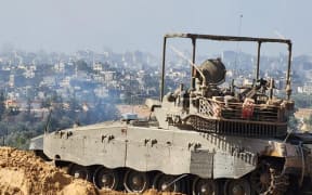 This handout picture released by the Israeli army on 15 November, 2023, shows soldiers on an armed vehicle during a military operation around at Al-Shifa hospital in Gaza City, amid continuing battles between Israel and the Palestinian militant group Hamas.
