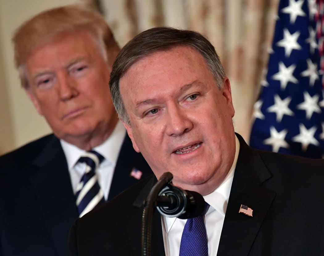 In this file photo taken on May 02, 2018, US President Donald Trump watches Mike Pompeo speak during his ceremonial swearing-in as US Secretary of State at the State Department in Washington, DC .