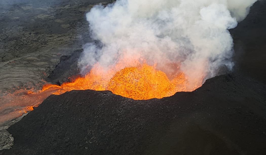 Kilauea Volcano, Hawaii, on 18 June.The image was obtained from the US Geological Survey and shows a view of Fissure 8  lava fountain as it pulses to heights of 50 m (165 ft) within a cinder spatter cone.