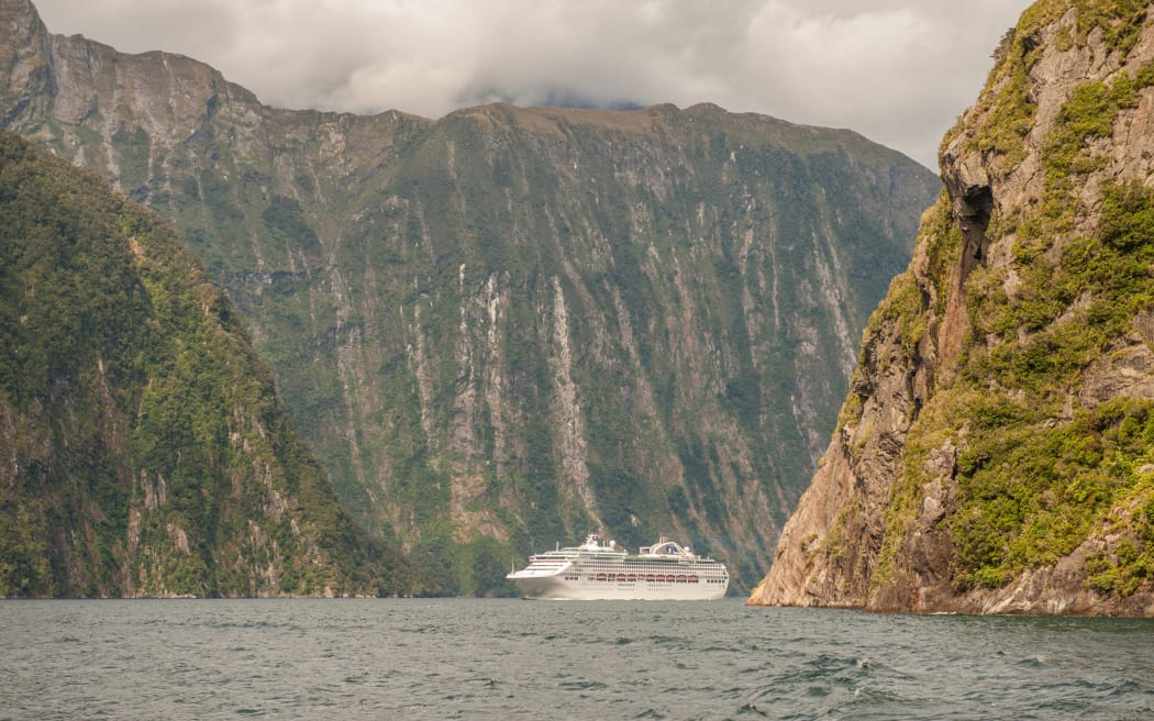 Milford Sound, New Zealand  February 14, 2012: Cruise ship cruising in Milford Sound. This fiord is considered as one of the most scenic places in the world.