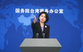 Zhu Fenglian, a spokesperson for the State Council Taiwan Affairs Office, gestures at a press conference in Beijing, capital of China, 13 December 2023.