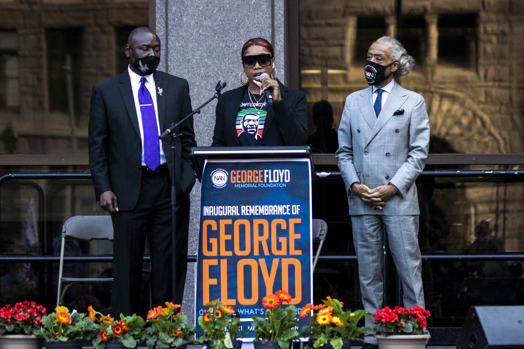 George Floyd's sister Bridgett Floyd (C) speaks, flanked by Rev. Al Sharpton (R), the founder and President of National Action Network, and Attorney Ben Crump (L), during a remembrance for George Floyd in Minneapolis, Minnesota, on May 23, 2021. -