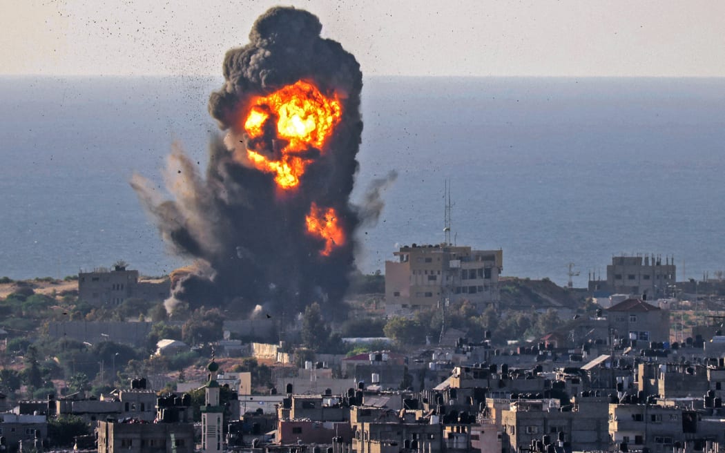 Smoke billows from an explosion following an Israeli air strike in Rafah in the southern Gaza Strip on 13 May 2021.