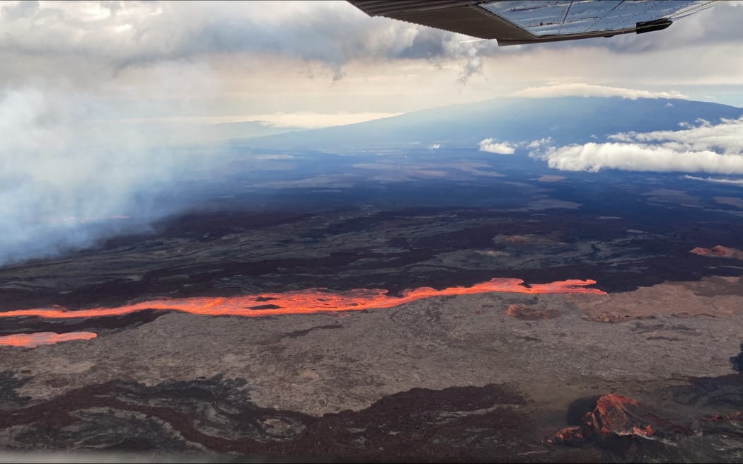 This aerial image released by the US Geological Survey (USGS) from Civil Air Patrol on November 28, 2022, shows the lava on the northeast rift zone of Mauna Loa in Hawaii. - Hawaii's Mauna Loa, the largest active volcano in the world, has erupted for the first time in nearly 40 years, US authorities said, as emergency crews went on alert early Monday. (Photo by Handout / US Geological Survey / AFP) / RESTRICTED TO EDITORIAL USE - MANDATORY CREDIT "AFP PHOTO / US Geological Survey " - NO MARKETING - NO ADVERTISING CAMPAIGNS - DISTRIBUTED AS A SERVICE TO CLIENTS