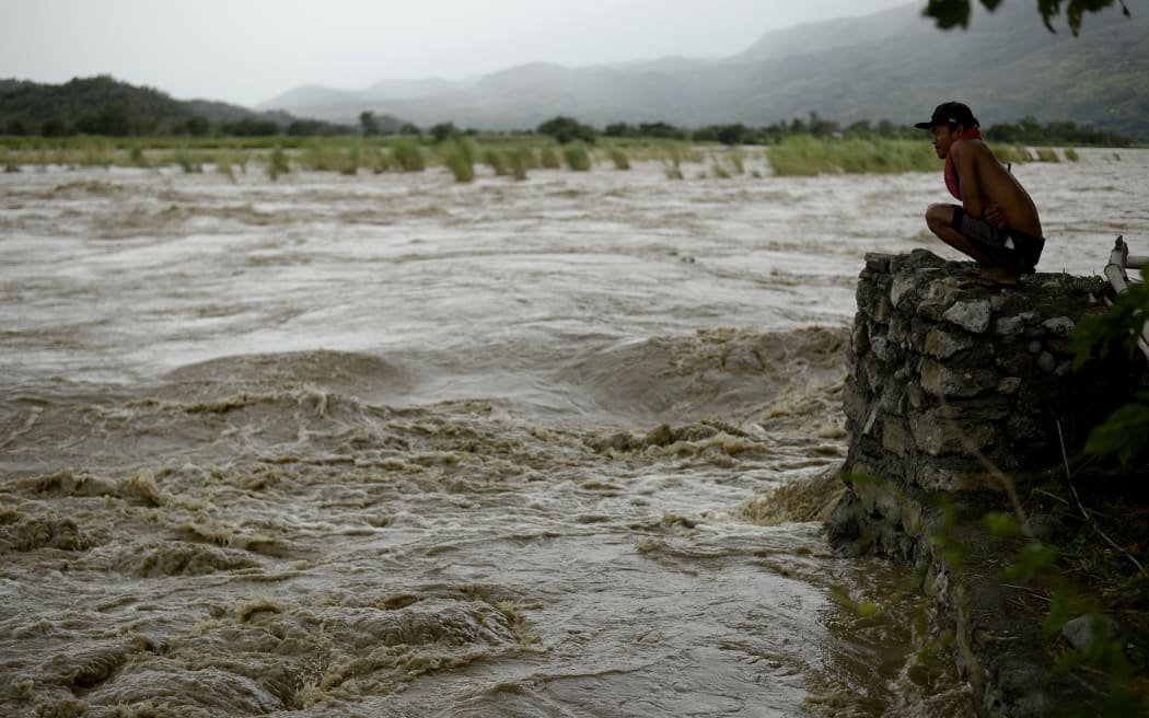 A man looks at the rising water level of the Magat River caused by continuous rains of Typhoon Koppu, October 18, 2015. AFP PHOTO