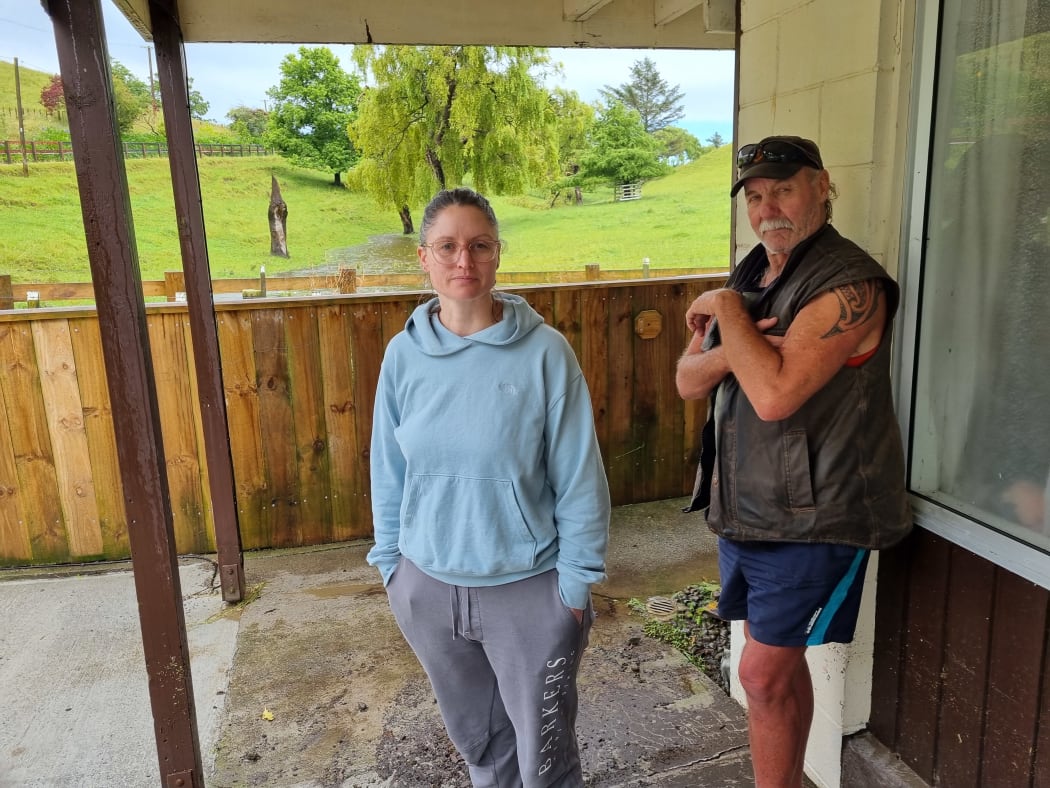 Alicia Field and Chris Pirret stand in front of the stream that turned into a torrent.