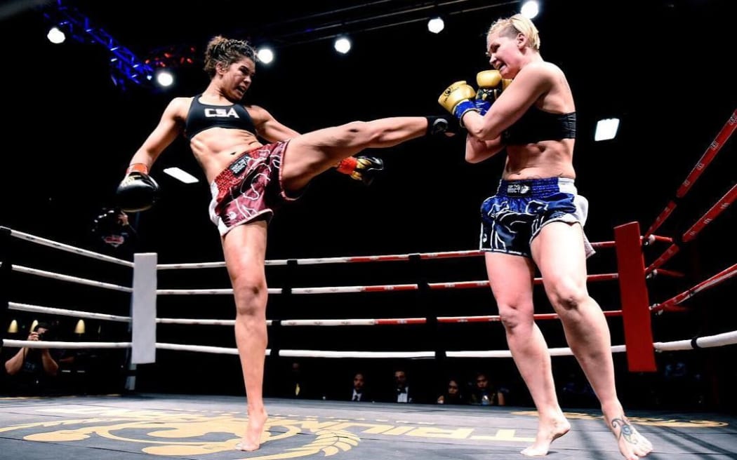 Fabian throwing a leg kick at Charmaine Tweet in WMC title fight in March 2019