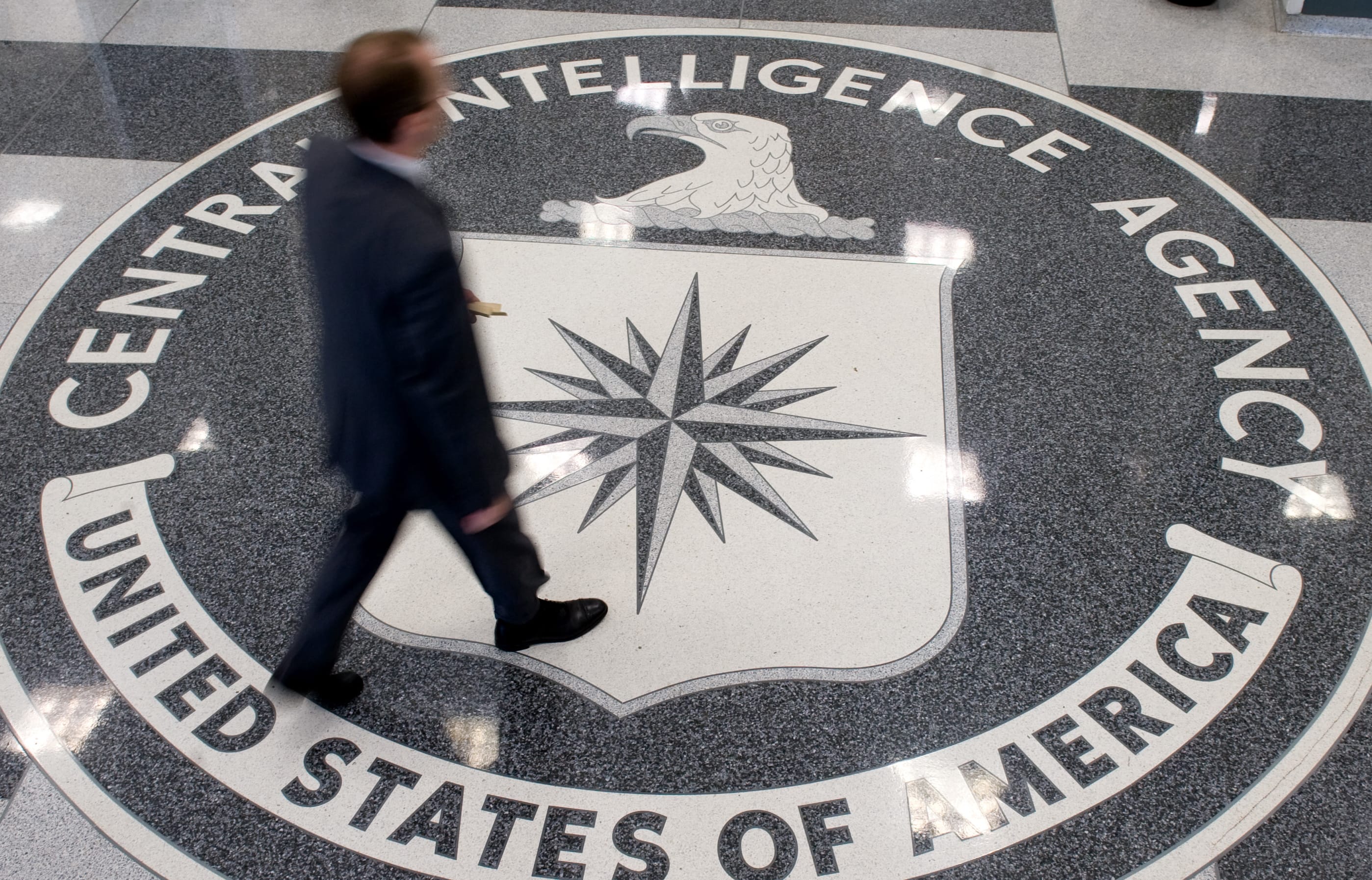 (File) A man crosses the Central Intelligence Agency (CIA) seal in the lobby of CIA Headquarters in Langley, Virginia, in 2018.