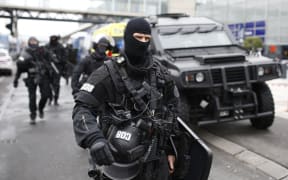 RAID police unit officers secure the area at the Paris' Orly airport on 18 March, 2017 following the shooting of a man by French security forces.