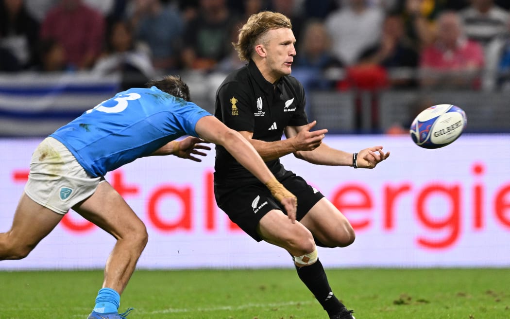 New Zealand's full-back Damian McKenzie passes the ball during the France 2023 Rugby World Cup Pool A match between New Zealand and Uruguay at the OL Stadium in Decines-Charpieu, near Lyon, south-eastern France, on 6 October, 2023.