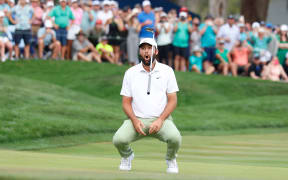 Scottie Scheffler reacts to missing a birdie putt on the 18th hole of The Players Championship.