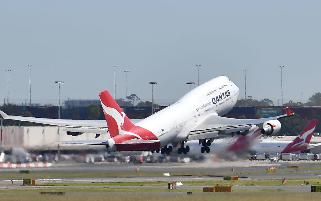 A Qantas Airways plane takes off at Sydney Airport in Sydney on March 19, 2020.