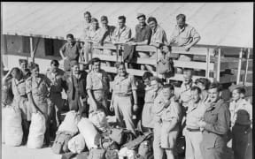 A group of repatriated New Zealand prisoners of war unloading their few belongings from a truck at Maadi Camp, Egypt, during World War II. These NZ POWs made their own way from Italian POW camps to connect with the British forces in southern Italy.