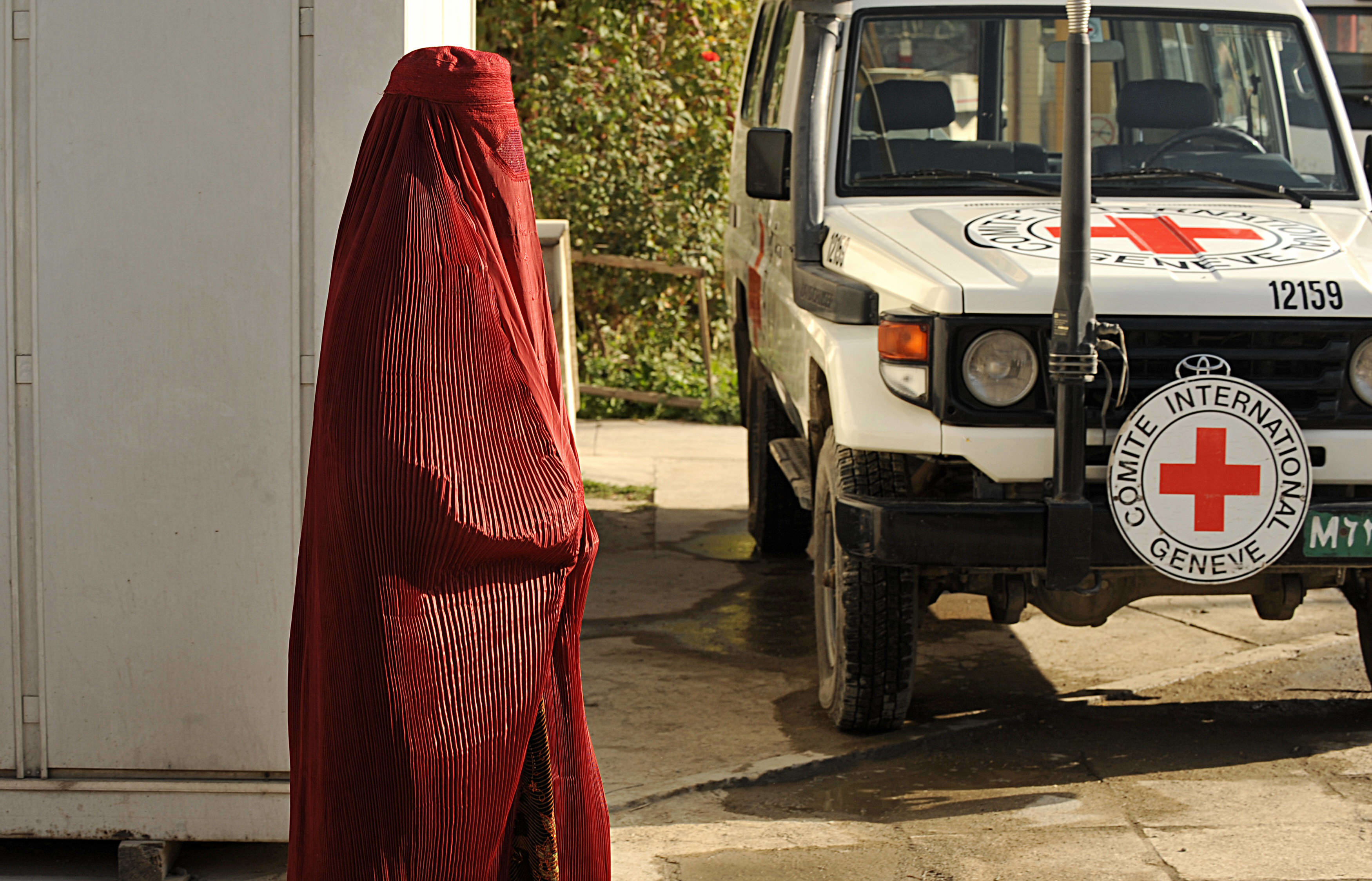 A woman walks past a Red Cross vehicle in Kabul (file photo).
