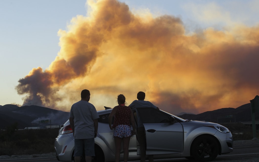 People watch the Blue Cut wildfire in Lytle Creek, California.