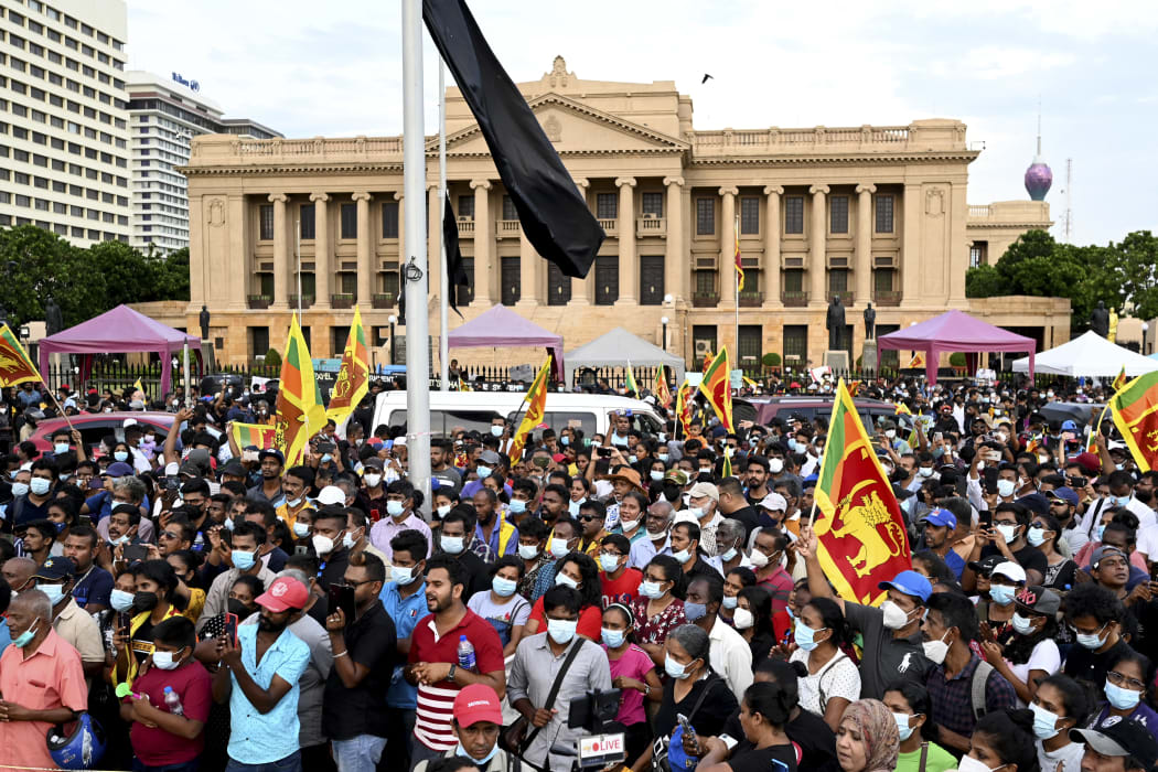 Protesters take part in a demonstration against the economic crisis near president's office in Colombo on April 17, 2022,  (Photo by ISHARA S. KODIKARA / AFP)
