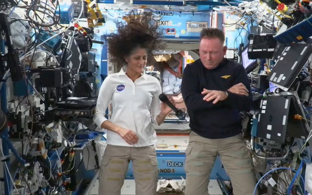 In this still image taken from a NASA TV broadcast, NASA astronauts Butch Wilmore (R) and Suni Williams hold a news conference from the International Space Station (ISS) on September 13, 2024. Wilmore and Williams, who arrived at the ISS aboard Boeing's Starliner, will return home with rival SpaceX in February 2025, NASA has said. (Photo by Handout / NASA TV / AFP) / RESTRICTED TO EDITORIAL USE - MANDATORY CREDIT "AFP PHOTO / NASA TV" - NO MARKETING NO ADVERTISING CAMPAIGNS - DISTRIBUTED AS A SERVICE TO CLIENTS