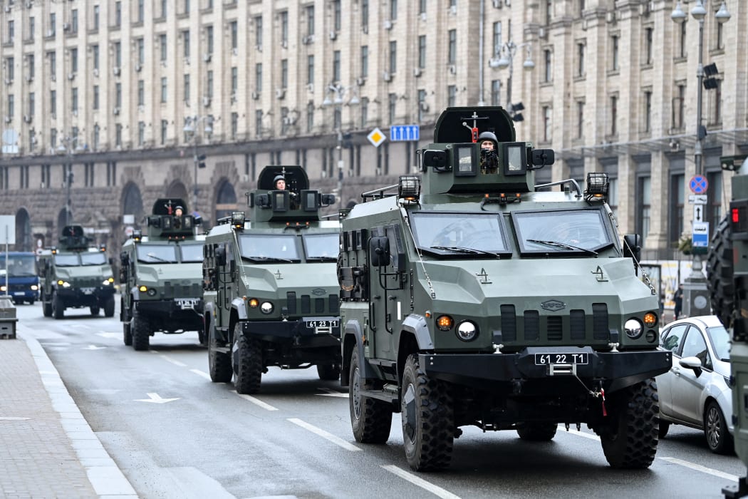 Ukrainian military vehicles move past Independence square in central Kyiv on February 24, 2022.