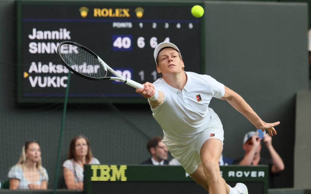 Jannik Sinner stretches to return a shot against Aleksandar Vukic during their second round match in the men's singles at Wimbledon, 3 July, 2025. (Photo by Daisuke Urakami / The Yomiuri Shimbun via AFP)