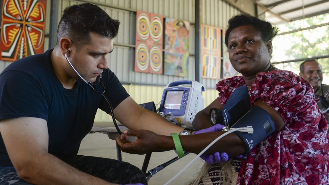 Papua New Guinea (July 7, 2015) Hospitalman Jaime Cavalleroserna, from San Francisco, takes patient vitals during a community health engagement. Medical personnel from the hospital ship USNS Mercy (T-AH 19) arrived in Kokopo  during Pacific Partnership 2015.