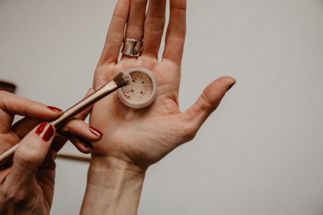 woman's hands with makeup product