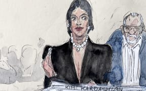 (FILES) This court sketch made on May 13, 2025 in Paris shows US celebrity Kim Kardashian (C), next to co-accused Aomar Ait Khedache, testifying before the Assize Court for the trial over the 2016 robbery that saw her relieved of millions of dollars' worth of jewellery at gunpoint. French prosecutors on May 21, 2025, requested that the alleged mastermind behind the robbery of reality TV star Kim Kardashian be sentenced to 10 years in prison. Aomar Ait Khedache, 69, has admitted to tying up Kardashian, but denies being the ringleader of the robbery. (Photo by Benoit PEYRUCQ / AFP)
