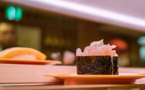 Plates of sushi on a conveyor belt at a sushi chain restaurant in Tokyo on 3 February, 2023.