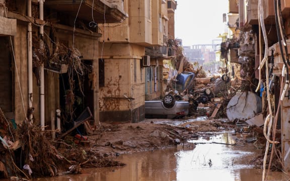 Overturned cars lie among other debris caused by flash floods in Derna, eastern Libya, on September 11, 2023.