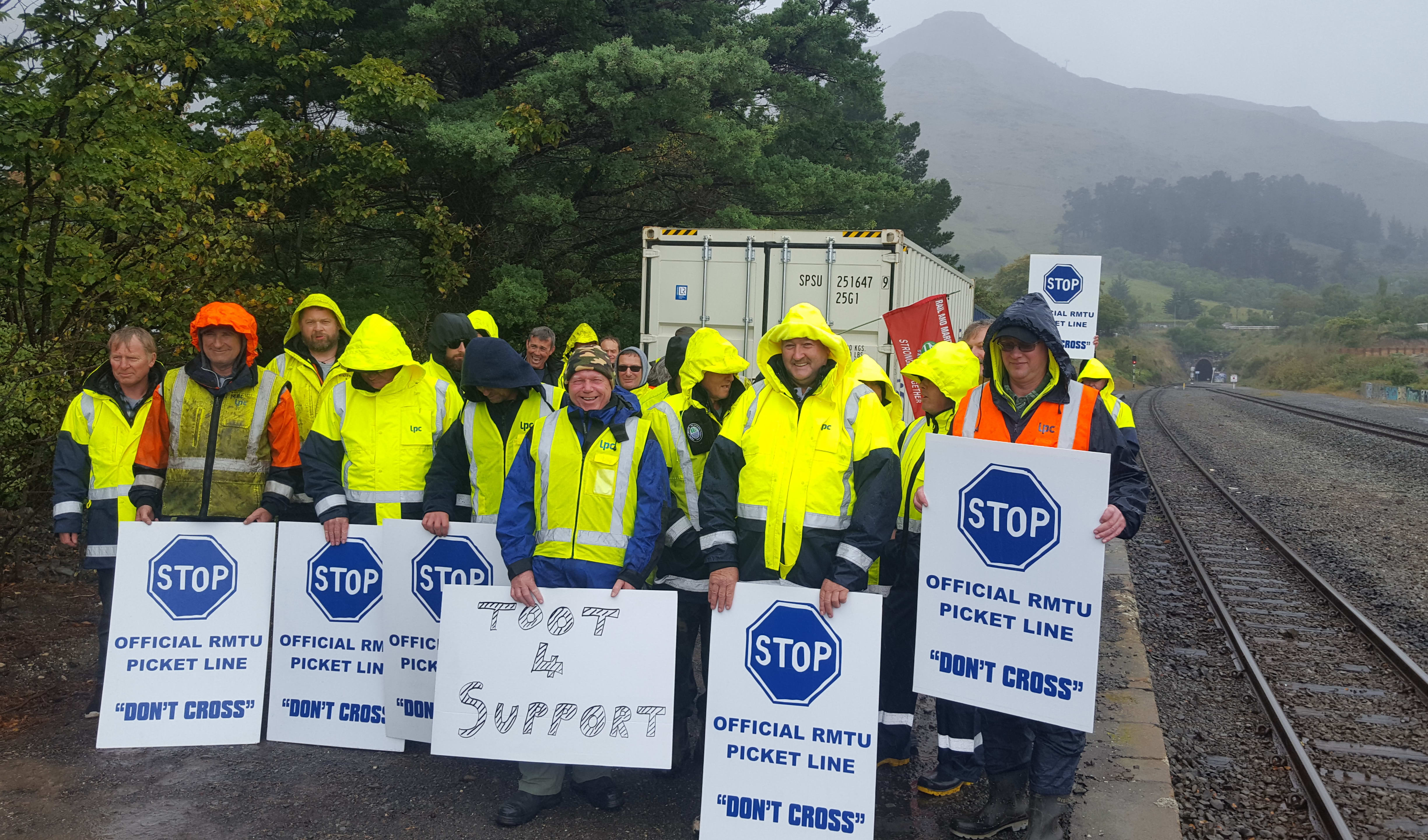 Picketing workers near rail tunnel entrance