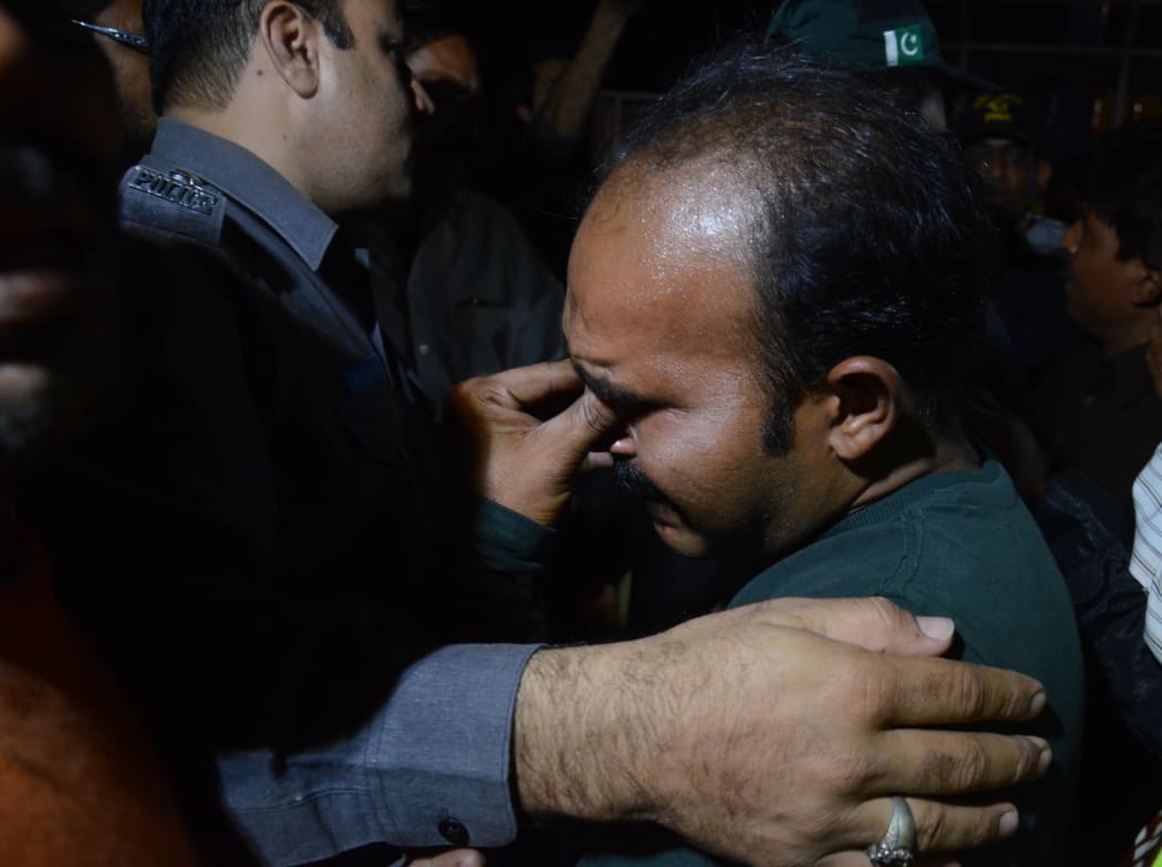 A relative of a victim mourns after a suicide attack in a crowded park in Lahore.