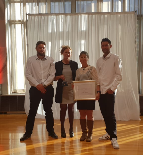 Scott Theobald's family collect his posthumous public service award for conservation. From left, his son Nathan Theobald, ex-wife Jackie Welsh, wife Adriana Theobald and son Conrad Theobald.