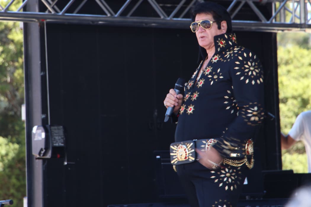 Elvis tribute artist Kerryn Winn performing at Elvis in the Gardens .