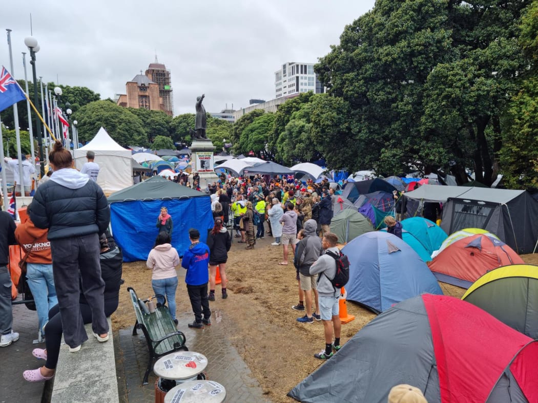 Protesters at Parliament after a night of heavy rain.