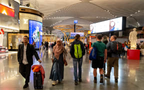 Passengers walk the allies of Istanbul Airport, in the capital of Turkiye on November 3, 2024. Istanbul Airport was named the second busiest airport in Europe and second busiest in the Middle East. (Photo by Dominika Zarzycka/NurPhoto) (Photo by Dominika Zarzycka / NurPhoto via AFP)