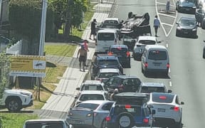 A car flips on Waipa St on Auckland's North Shore