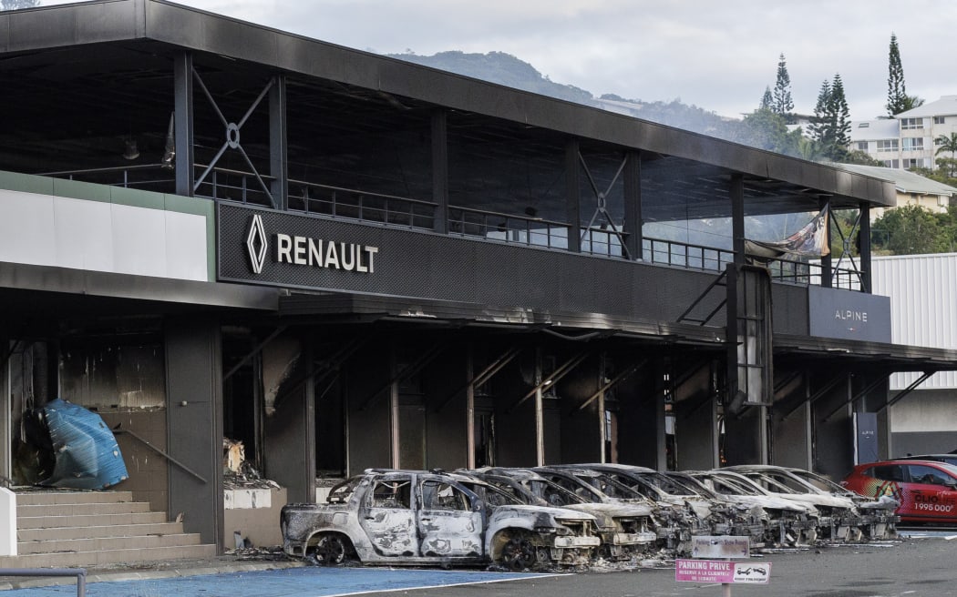 FILE - A burnt car store is pictured in Noumea, New Caledonia, on May, 14, 2024. Global nickel prices have soared since deadly violence erupted in the French Pacific territory of New Caledonia. (AP Photo/Cedric Jacquot, File)