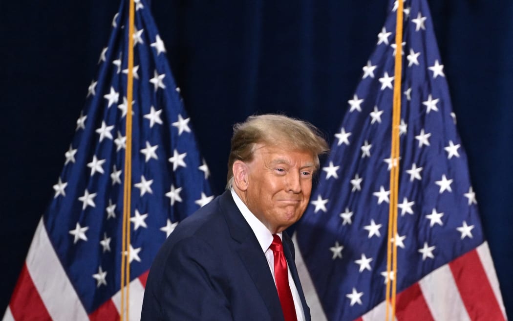 Former US President and Republican presidential hopeful Donald Trump arrives to speaks at a watch party during the 2024 Iowa Republican presidential caucuses in Des Moines, Iowa, on January 15, 2024. Trump told Americans Monday "it is time for our country to come together" after he won the Iowa caucuses, cementing his status as the likely Republican challenger to take on President Joe Biden in November's election. (Photo by Jim WATSON / AFP)