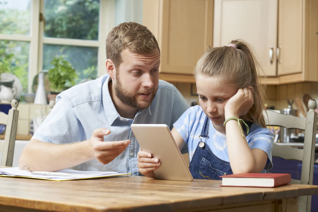 Dad Helping Girl Struggling With Studies
