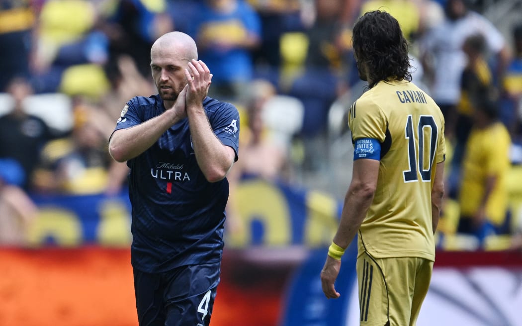 Auckland City's New Zealand defender #04 Christian Gray (L) celebrates scoring his team's first goal next to Boca Juniors' Uruguayan forward #10 Edinson Cavani during the FIFA Club World Cup 2025 Group C football match between New Zealand's Auckland City and Argentina's Boca Juniors at the Geodis Park stadium in Nashville on June 24, 2025.