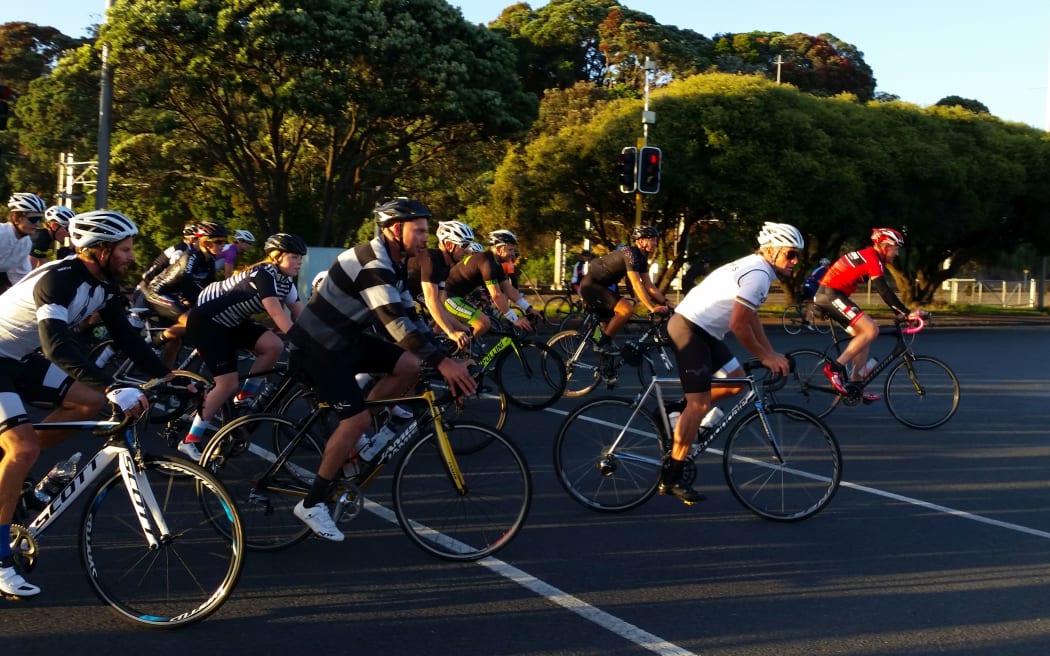 Lance Armstrong (in white) returns from a waterfront bike ride in Auckland.