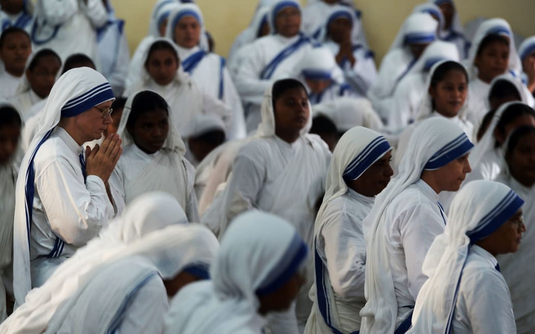 Nuns from the Missionaries of Charity attend mass to commemorate the 105th birthday of Mother Teresa in Kolkata.