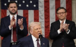 US Speaker of the House Mike Johnson (R-LA) and Vice President JD Vance (L) applaud as US President Donald Trump addresses a joint session of Congress at the US Capitol in Washington, DC, on March 4, 2025. (Photo by Win McNamee / POOL / AFP)