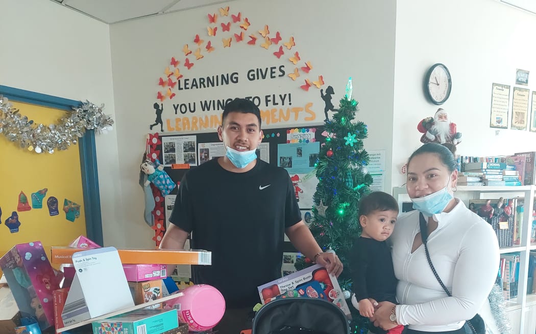 Santana and Tyrone deliver gifts to kids at Middlemore Hospital with their son Easton.