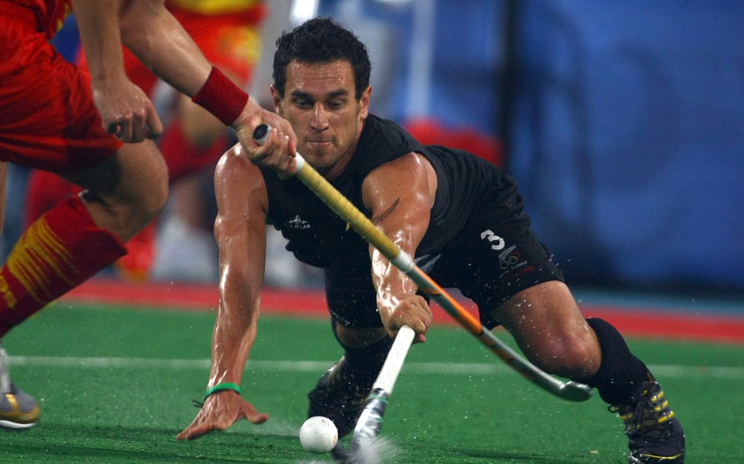 David Kosoof tackles the Spanish defence during the New Zealand men's hockey match against Spain at the Beijing Olympic Games.