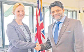 New Zealand High Commissioner to Fiji Charlotte Darlow and Fiji's Attorney-General and Minister for Economy Aiyaz Sayed-Khaiyum seal the deal with a handshake.
