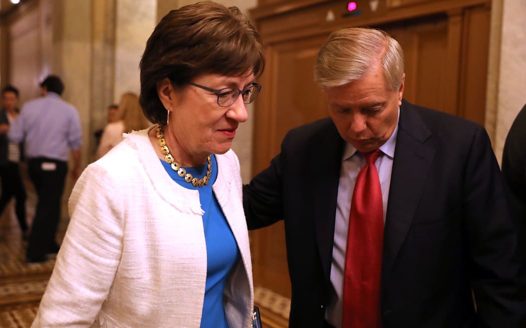 Sen. Susan Collins (L) and Sen. Lindsey Graham leaving the the Senate chamber at the US Capitol after voting on the GOP 'Skinny Repeal' health care bill