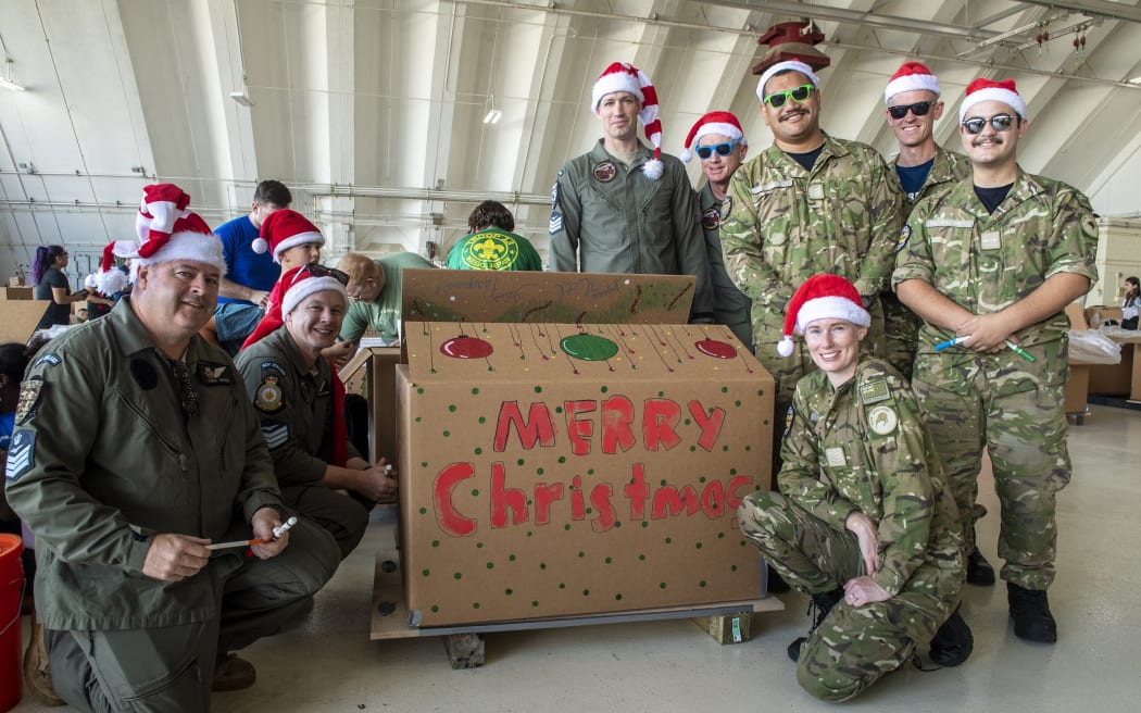 Utilising a hangar at Andersen Air Force Base, Guam, aircrew from the US, Japan, South Korea, Australia, New Zealand help build the bundles that will be delivered as part of Operation Christmas Drop.