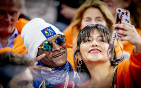 MILAN - Snoop Dogg among the crowd during the 500-meter long track speed skating event at the Milan Speed Skating Stadium at the Milan Winter Olympics. ROBIN UTRECHT netherlands out - belgium out (Photo by ROBIN UTRECHT / ANP MAG / ANP via AFP)