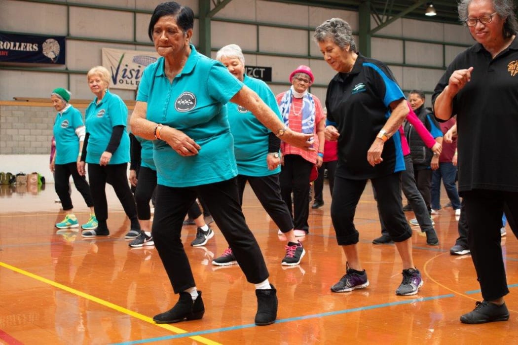 Kaumatua doing line dancing and practicing sparring